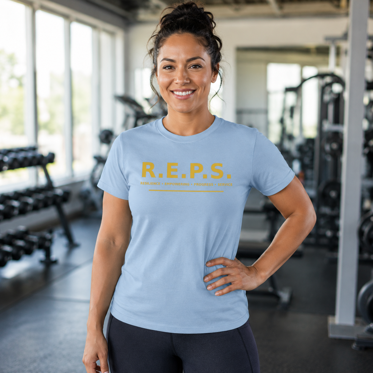 Woman wearing the light blue R.E.P.S. Gold Standard Tee in a gym