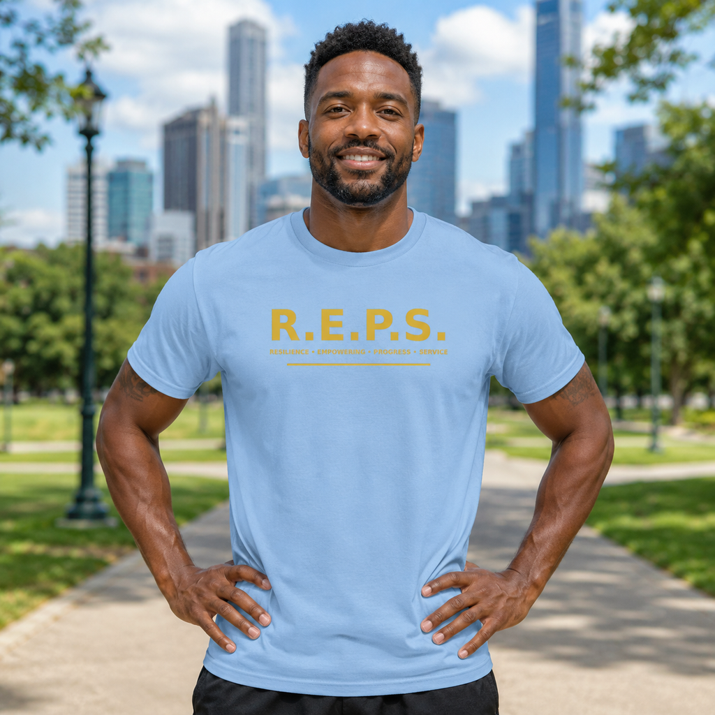 Man wearing the light blue R.E.P.S. Gold Standard Tee in a city park