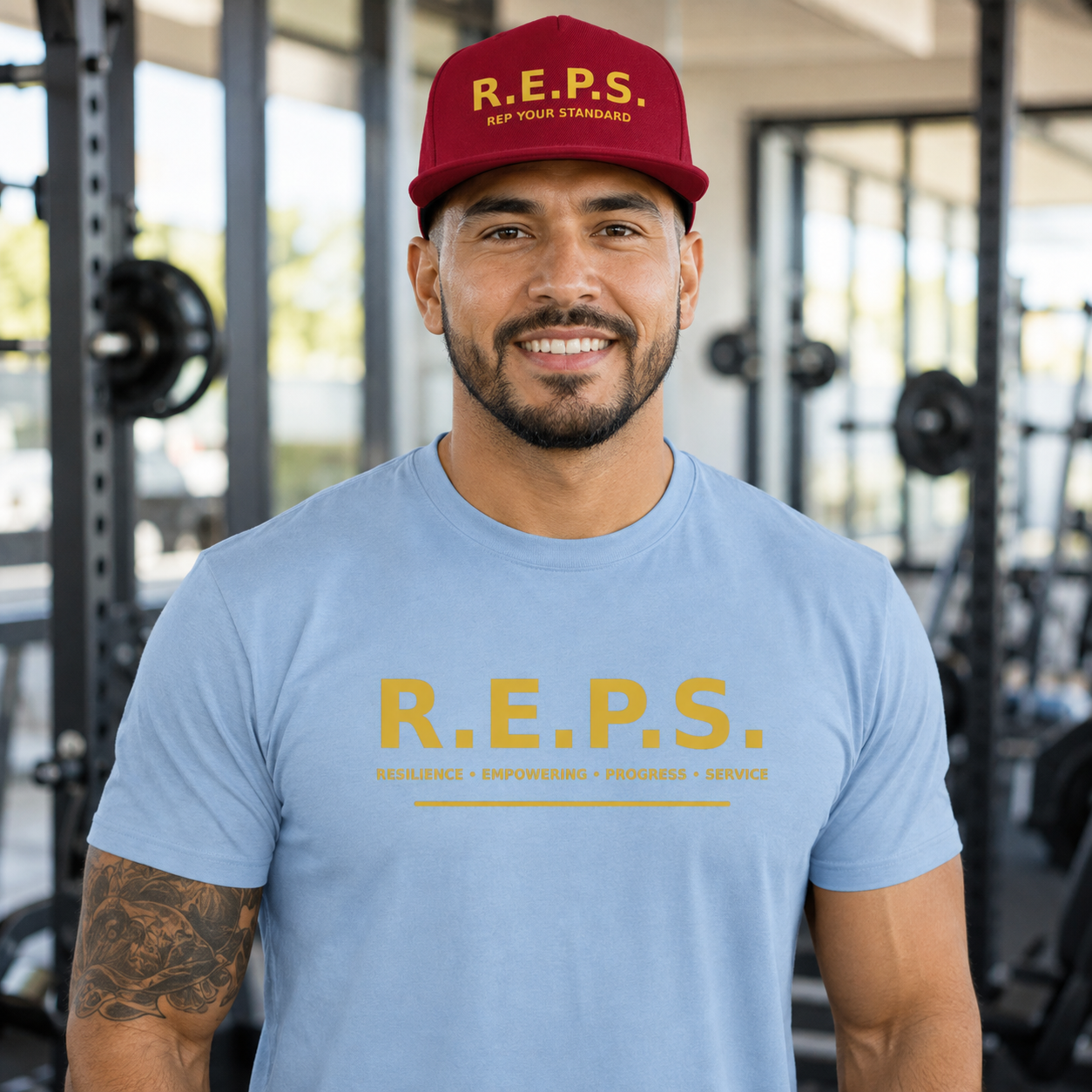 Man wearing the deep red R.E.P.S. Rep Your Standard snapback with a light blue R.E.P.S. shirt